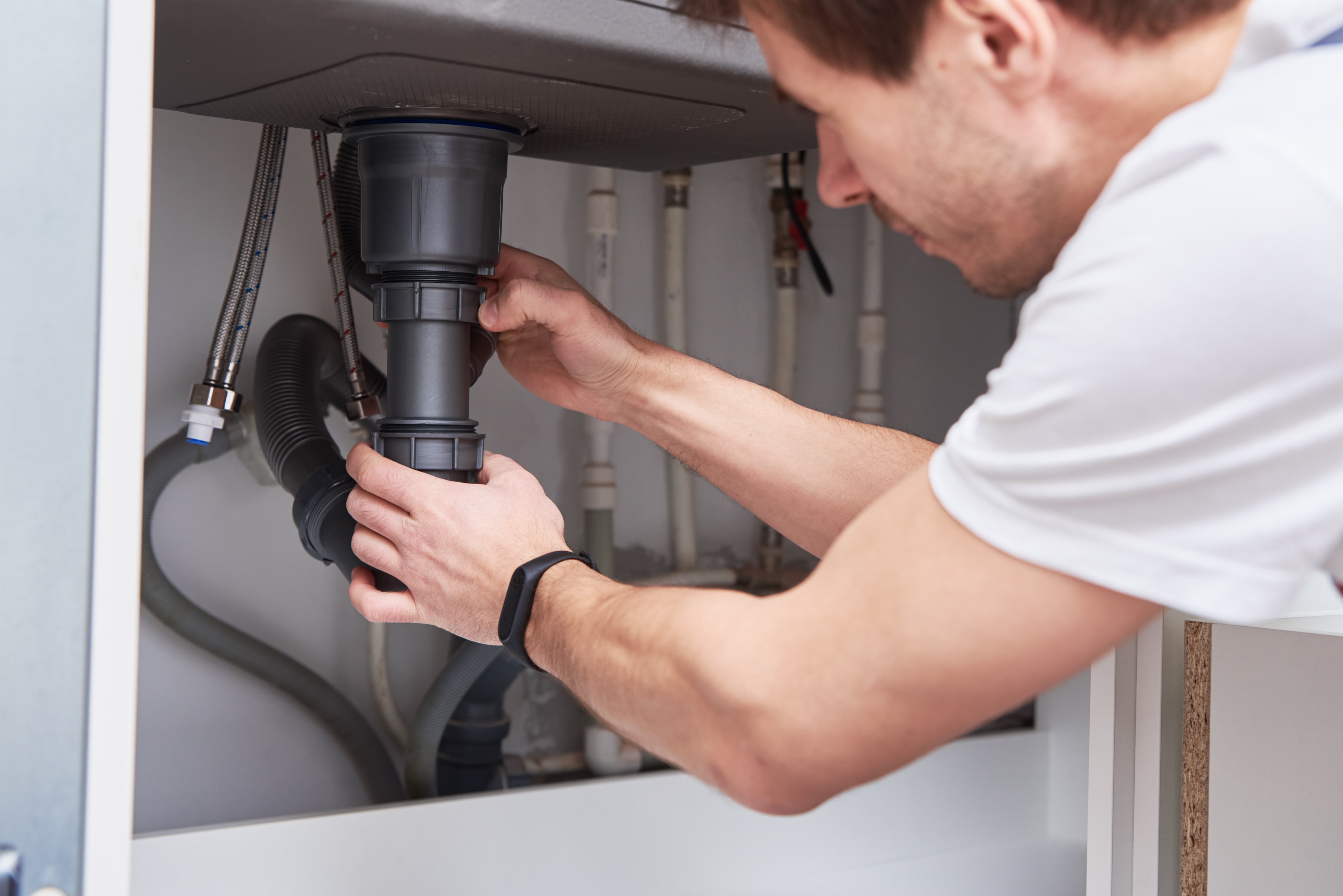 male-plumber-repair-sink-pipe-kitchen